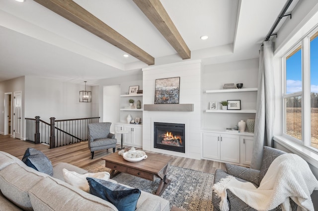 548 Mallard St NE, Hanover, MN 55341 - living area with wood finished floors, beamed ceiling, a large fireplace, built in features, and recessed lighting