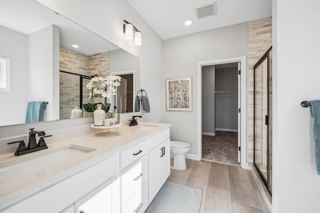 548 Mallard St NE, Hanover, MN 55341 - bathroom with a shower stall, double vanity, a spacious closet, and recessed lighting