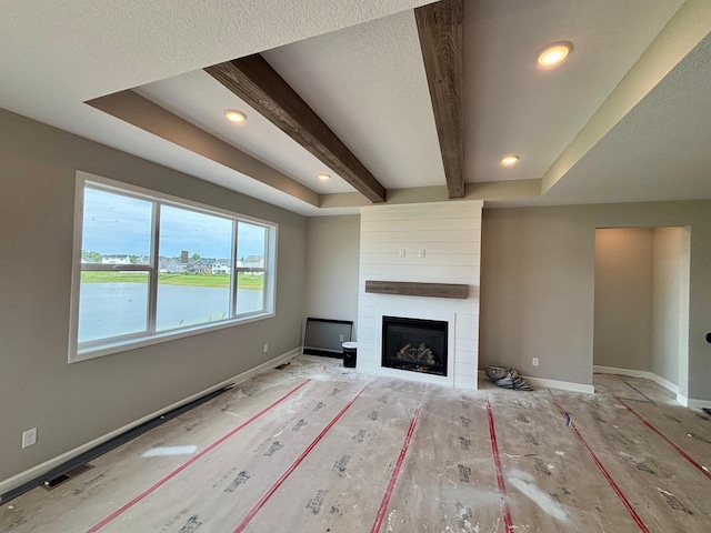 548 Mallard St NE, Hanover, MN 55341 - unfurnished living room with a fireplace, beam ceiling, recessed lighting, and a textured ceiling