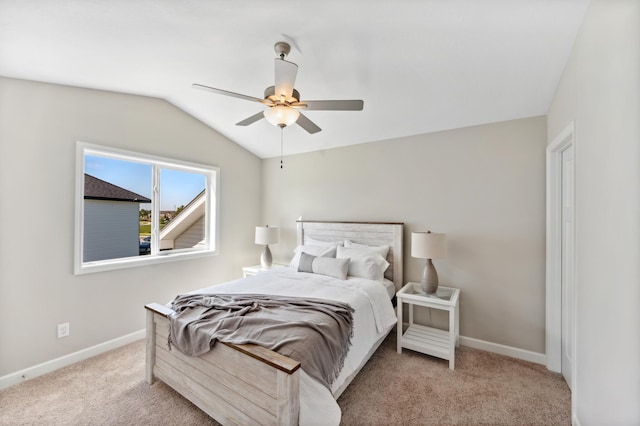 carpeted bedroom with baseboards, ceiling fan, and vaulted ceiling