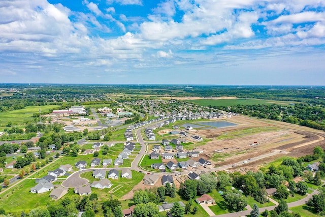birds eye view of property with a water view and a residential view