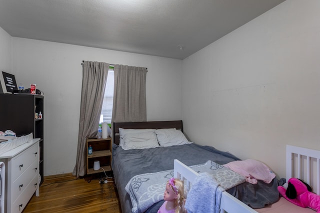 bedroom with wood finished floors