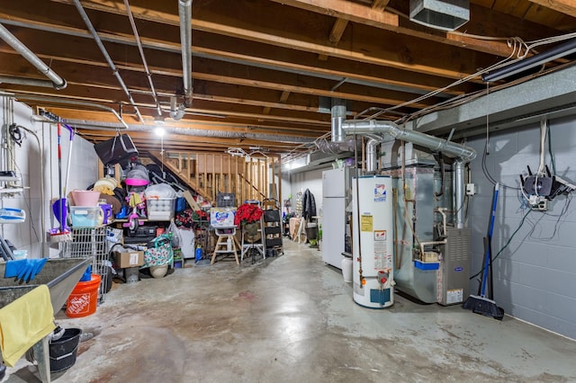 unfinished basement with water heater, freestanding refrigerator, and heating unit