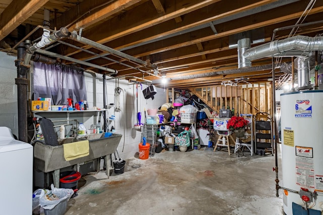 unfinished basement featuring water heater, a sink, and washer / clothes dryer