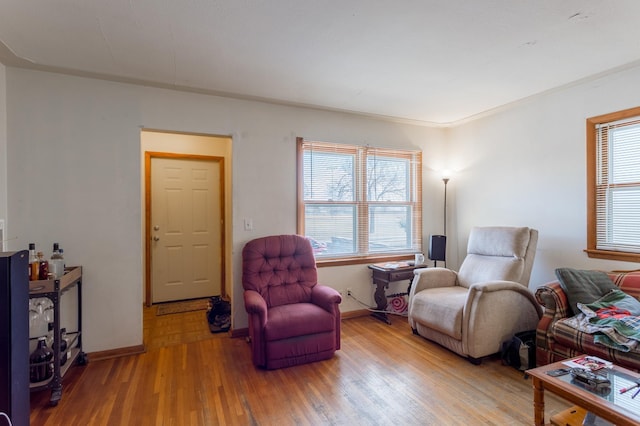 sitting room with baseboards and wood finished floors