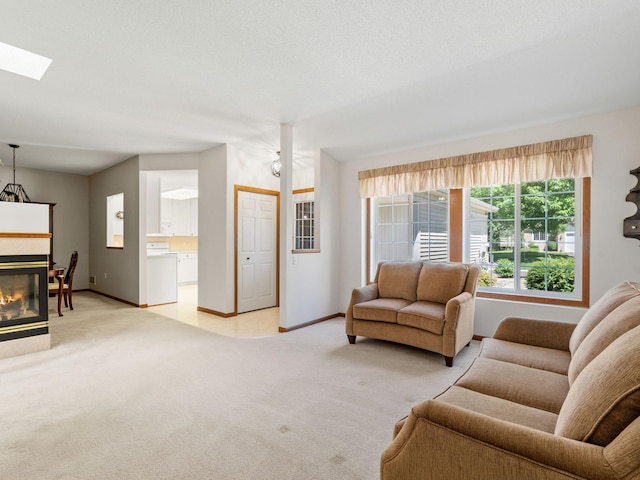 9323 Kimberly Ln N, Maple Grove, MN 55311 - living area featuring light carpet, a skylight, and a glass covered fireplace