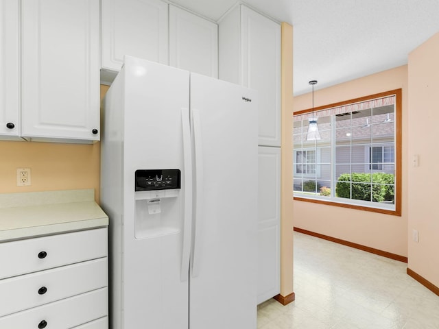 9323 Kimberly Ln N, Maple Grove, MN 55311 - kitchen with white refrigerator with ice dispenser, white cabinetry, light countertops, light floors, and pendant lighting