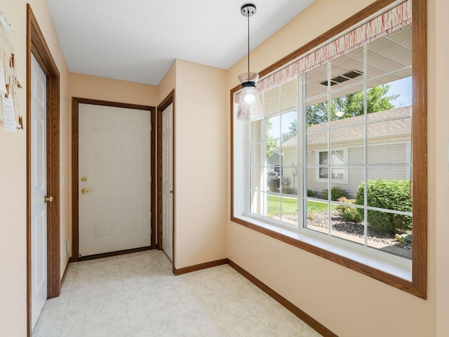 9323 Kimberly Ln N, Maple Grove, MN 55311 - doorway with baseboards and light flooring