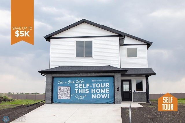 861 2nd Ave, Horace, ND 58047 - view of front of home with an attached garage, brick siding, and concrete driveway