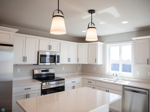 861 2nd Ave, Horace, ND 58047 - kitchen with appliances with stainless steel finishes, a sink, a center island, pendant lighting, and white cabinets