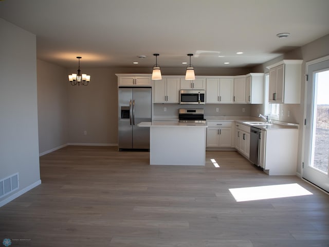 861 2nd Ave, Horace, ND 58047 - kitchen with stainless steel appliances, recessed lighting, healthy amount of natural light, a sink, and white cabinets