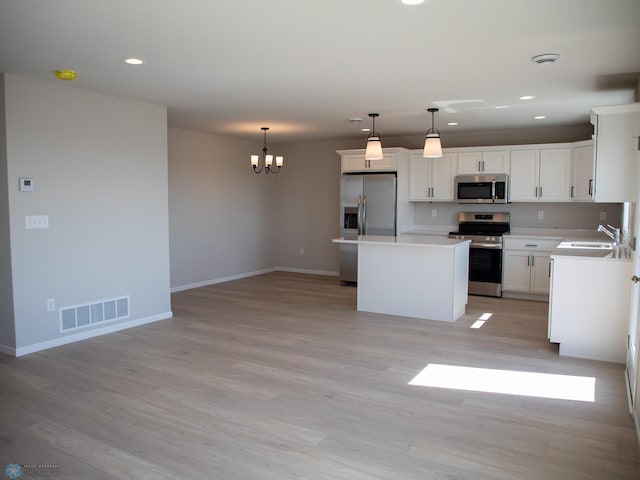 861 2nd Ave, Horace, ND 58047 - kitchen with appliances with stainless steel finishes, a sink, recessed lighting, a chandelier, and a center island