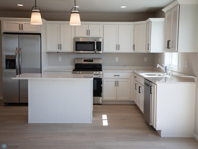 861 2nd Ave, Horace, ND 58047 - kitchen with appliances with stainless steel finishes, recessed lighting, a sink, white cabinetry, and a center island