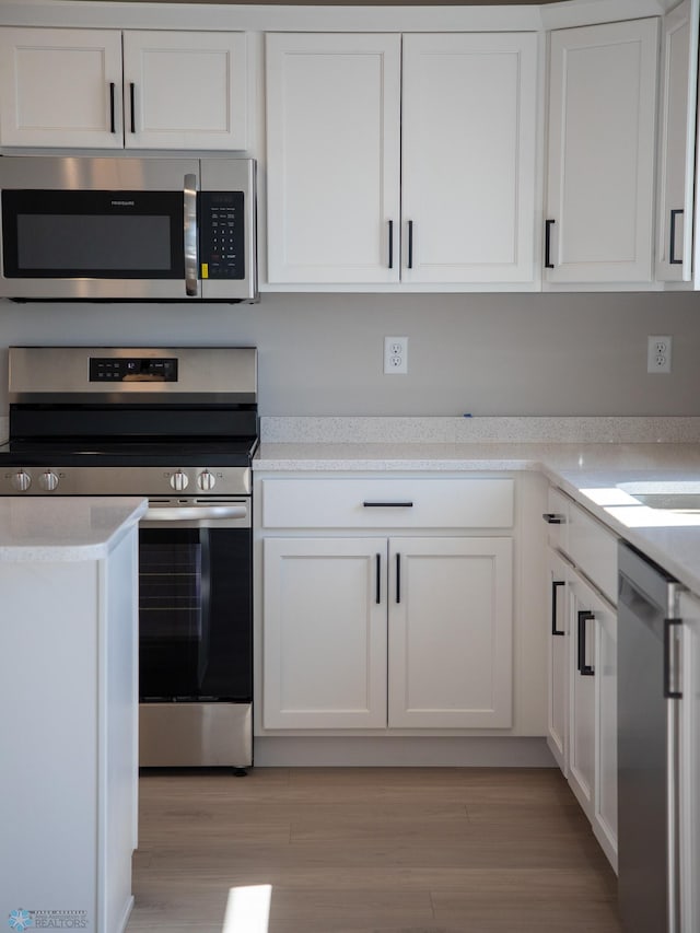 861 2nd Ave, Horace, ND 58047 - kitchen featuring stainless steel appliances, white cabinetry, light countertops, and light wood-style floors