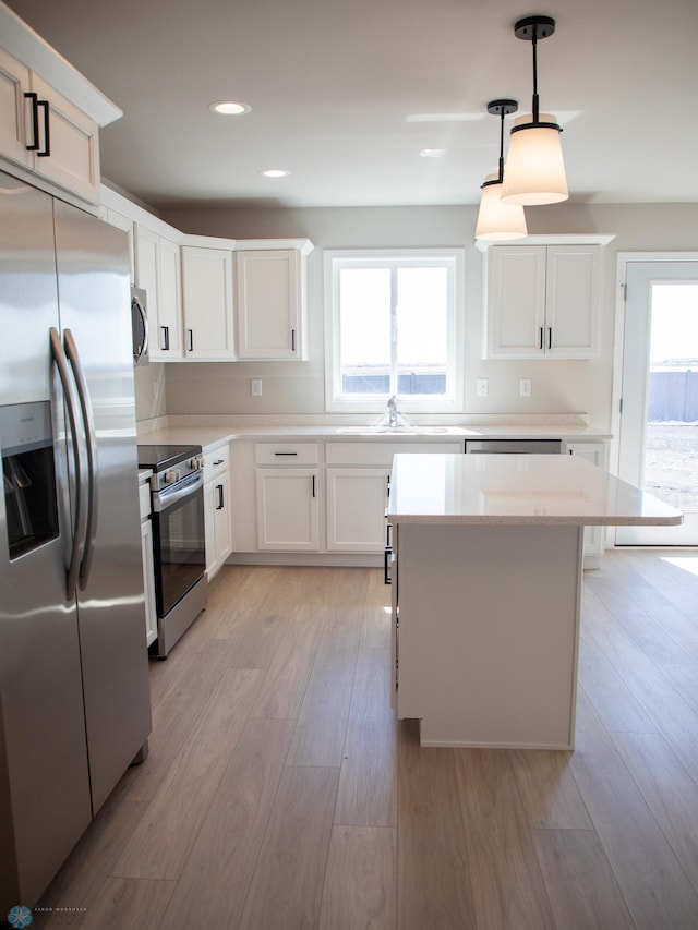 861 2nd Ave, Horace, ND 58047 - kitchen with stainless steel appliances, a sink, light wood-type flooring, light countertops, and white cabinets
