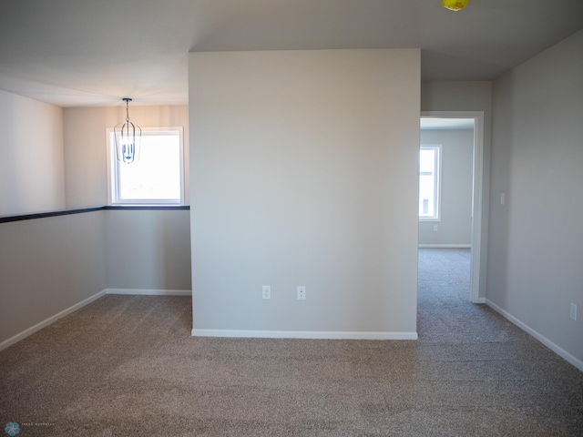 861 2nd Ave, Horace, ND 58047 - spare room with carpet floors, a chandelier, and baseboards