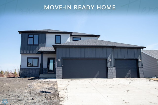 10202 Burgundy Dr, Horace, ND 58047 - prairie-style home with an attached garage, driveway, and brick siding