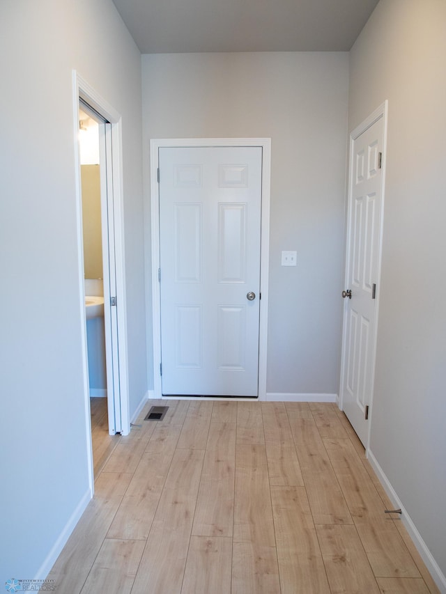 10202 Burgundy Dr, Horace, ND 58047 - hallway featuring light wood-type flooring, baseboards, and visible vents