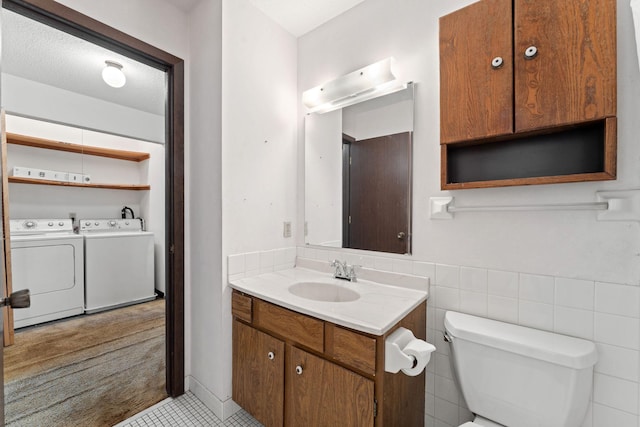 7508 Germane Trl Unit 0, Apple Valley, MN 55124 - bathroom with independent washer and dryer, toilet, tile patterned flooring, and vanity