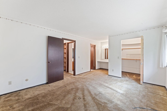 7508 Germane Trl Unit 0, Apple Valley, MN 55124 - unfurnished bedroom featuring carpet floors, a walk in closet, ensuite bath, a closet, and baseboards