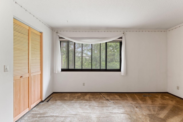 7508 Germane Trl Unit 0, Apple Valley, MN 55124 - unfurnished bedroom featuring carpet floors, a closet, baseboards, and a textured ceiling