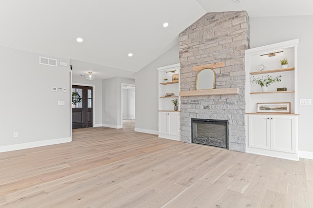 unfurnished living room featuring baseboards, light wood-type flooring, a fireplace, and visible vents