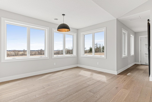 unfurnished sunroom featuring visible vents