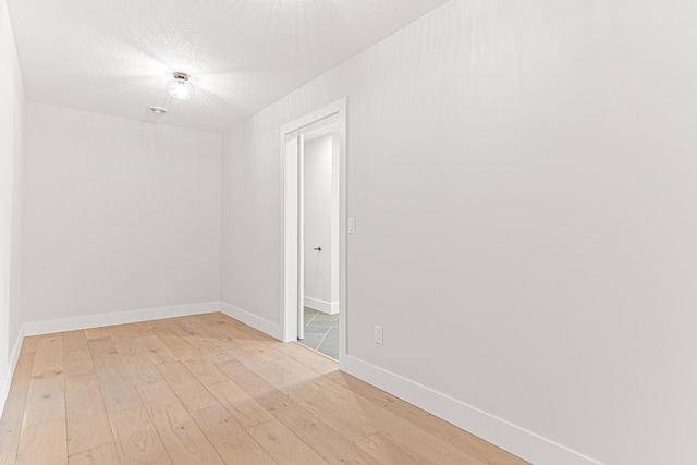 unfurnished room featuring light wood-style flooring and baseboards