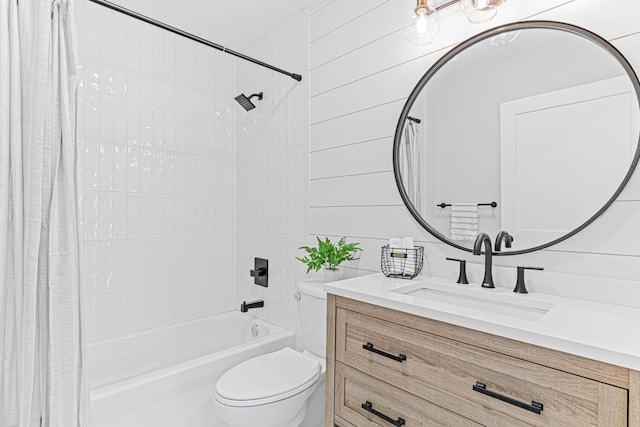 bathroom featuring vanity, shower / bath combination with curtain, and toilet