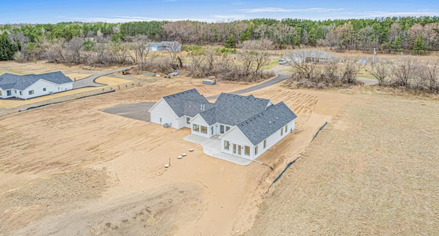 aerial view featuring a wooded view