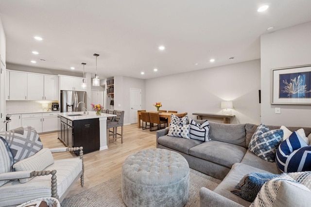 living room with recessed lighting and light wood-style flooring