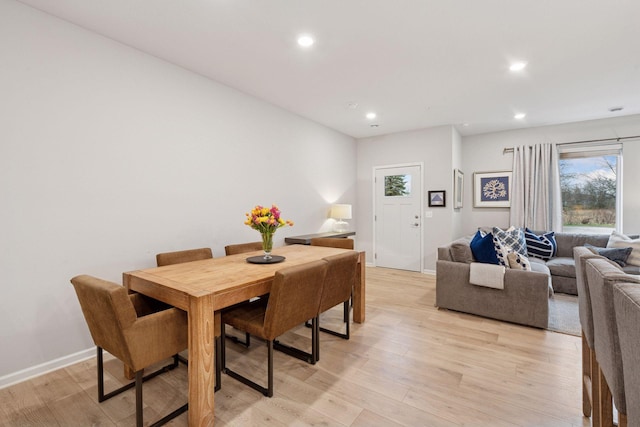 dining space with recessed lighting, baseboards, a healthy amount of sunlight, and light wood-type flooring