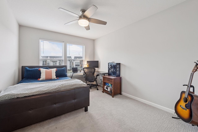 bedroom with baseboards, a ceiling fan, and light carpet