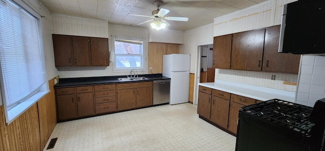 612 Mcpherson St, Littlefork, MN 56653 - kitchen featuring dishwasher, a sink, freestanding refrigerator, black gas stove, and light floors