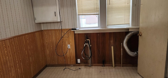 612 Mcpherson St, Littlefork, MN 56653 - clothes washing area with wood walls, wallpapered walls, a wainscoted wall, and light floors