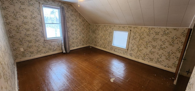 612 Mcpherson St, Littlefork, MN 56653 - bonus room featuring baseboards, vaulted ceiling, wallpapered walls, and dark wood finished floors