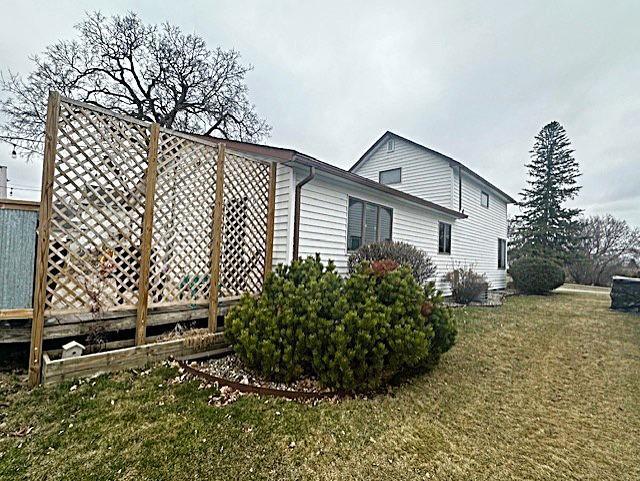 view of side of property with a yard