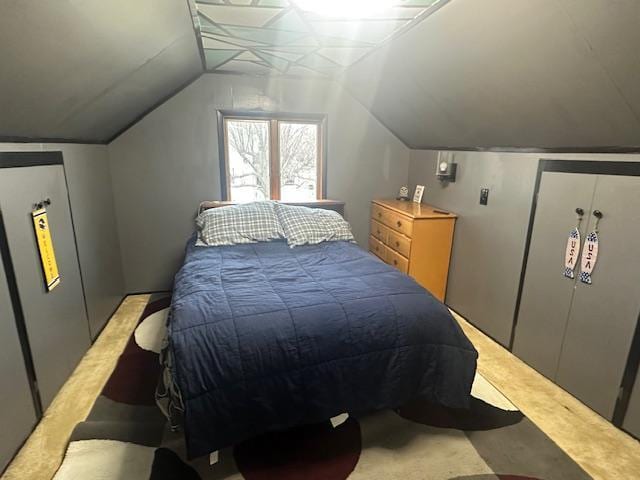 bedroom with vaulted ceiling and light carpet
