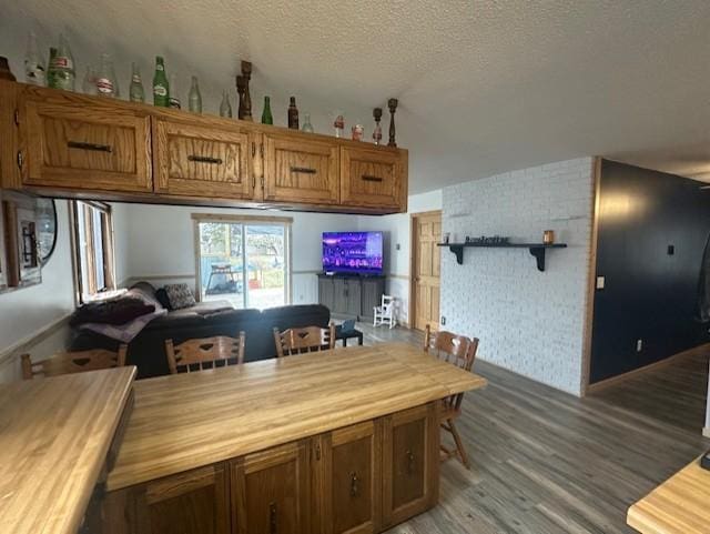 dining room with light wood-style flooring and a textured ceiling