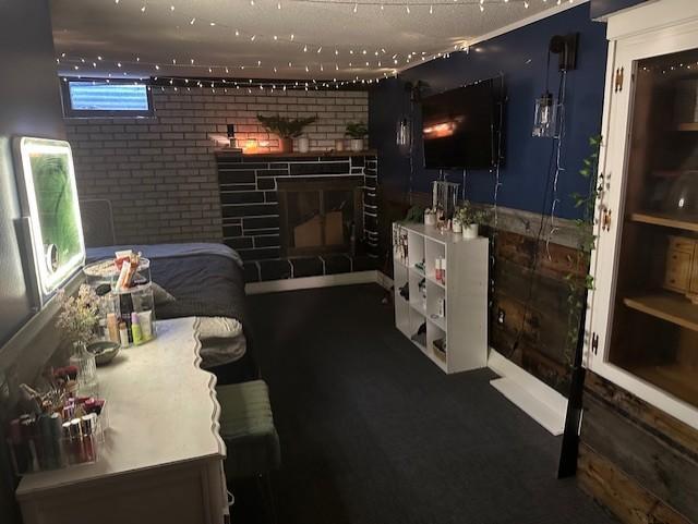 interior space with brick wall and a fireplace