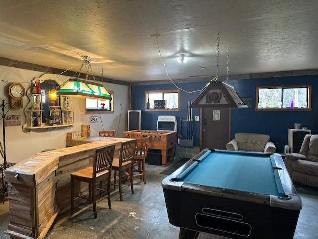 rec room featuring concrete flooring, a wealth of natural light, and pool table