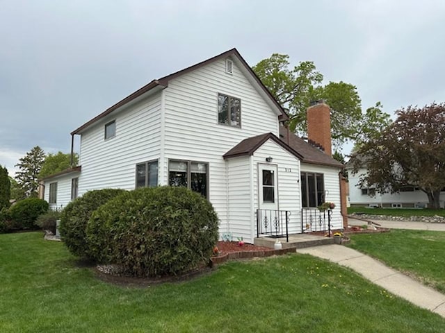 312 Melby Ave, Ashby, MN 56309 - rear view of house featuring a lawn and a chimney