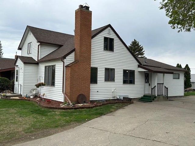 312 Melby Ave, Ashby, MN 56309 - back of property featuring a chimney, roof with shingles, and a lawn
