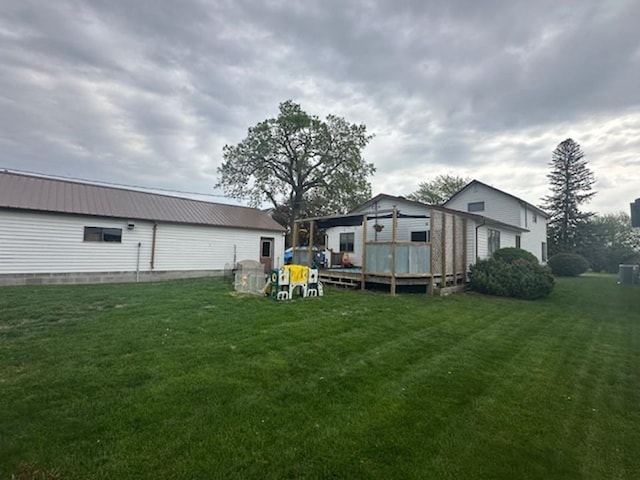 312 Melby Ave, Ashby, MN 56309 - view of green lawn with a wooden deck and central AC