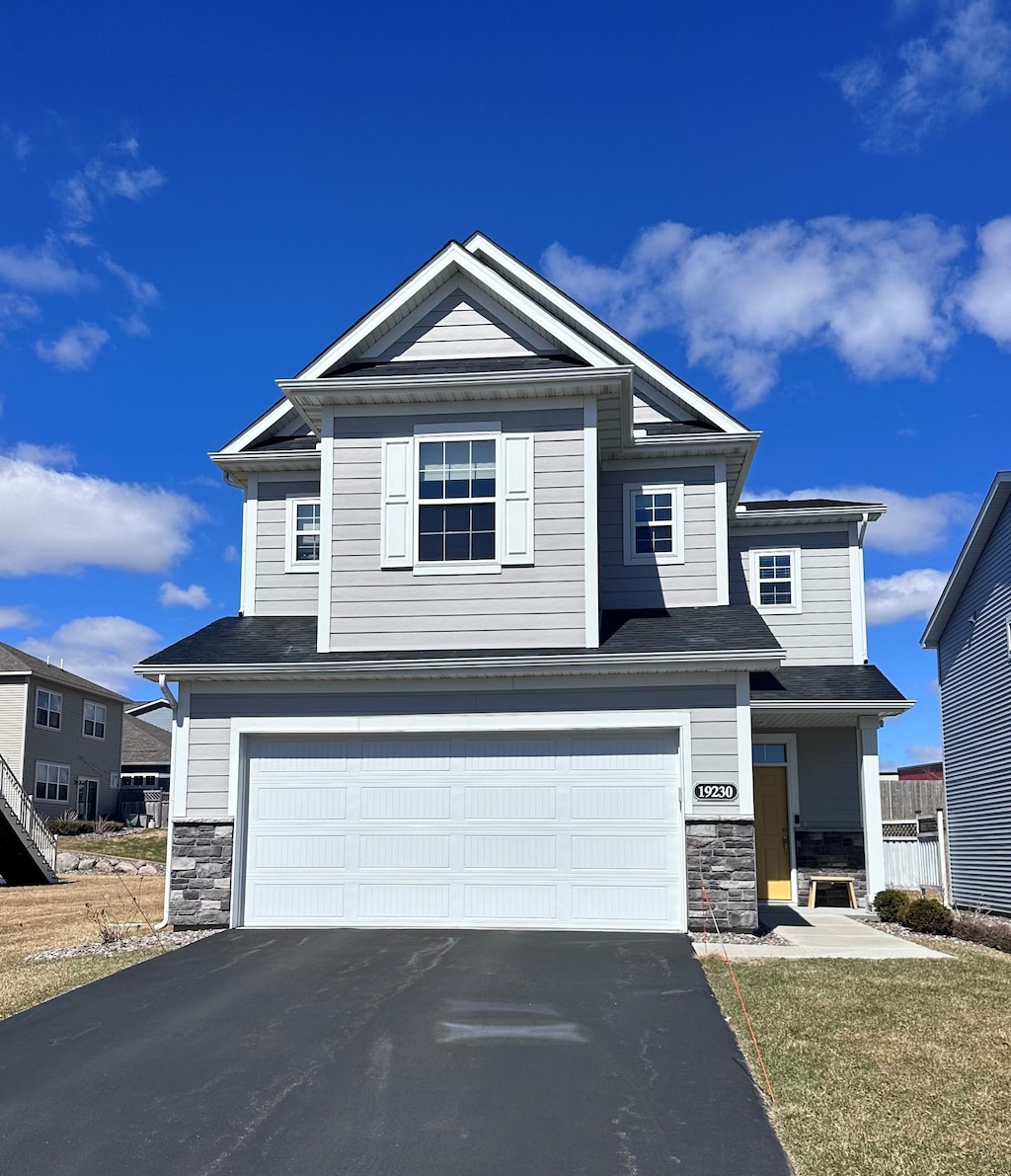 19230 72nd Ave N, Corcoran, MN 55340 - craftsman house with stone siding, an attached garage, and asphalt driveway