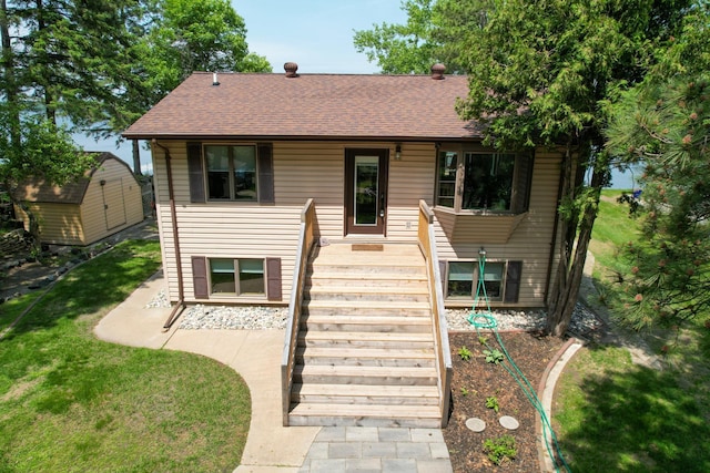 45257 Jack Pine Dr, Perham Twp, MN 56573 - view of front of home featuring a shingled roof, a front yard, and stairs
