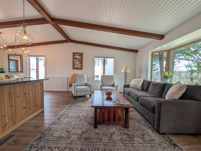 45257 Jack Pine Dr, Perham Twp, MN 56573 - living area featuring wainscoting, plenty of natural light, a chandelier, and dark wood-style flooring