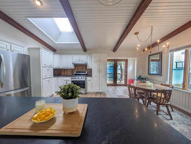 45257 Jack Pine Dr, Perham Twp, MN 56573 - living area with light wood-type flooring, plenty of natural light, beamed ceiling, and a chandelier