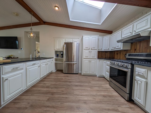 45257 Jack Pine Dr, Perham Twp, MN 56573 - kitchen featuring stainless steel appliances, under cabinet range hood, dark countertops, white cabinetry, and a skylight