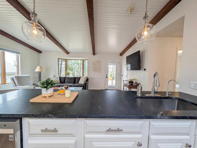 45257 Jack Pine Dr, Perham Twp, MN 56573 - kitchen featuring open floor plan, a sink, white cabinetry, decorative light fixtures, and wooden ceiling with exposed beams